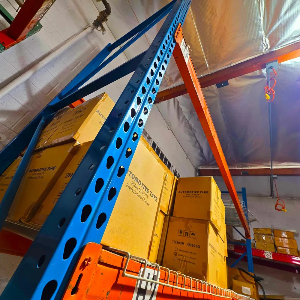 Pallet racks loaded with cases of tape in the EitanCo warehouse