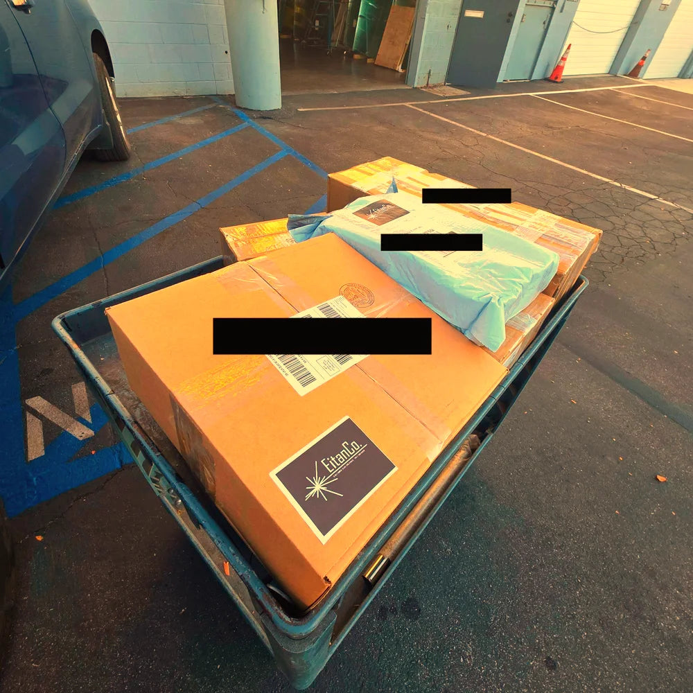 EitanCo tape boxes on a cart, out for delivery