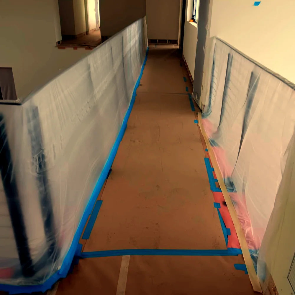 Hallway masked with plastic sheeting and blue painter's tape