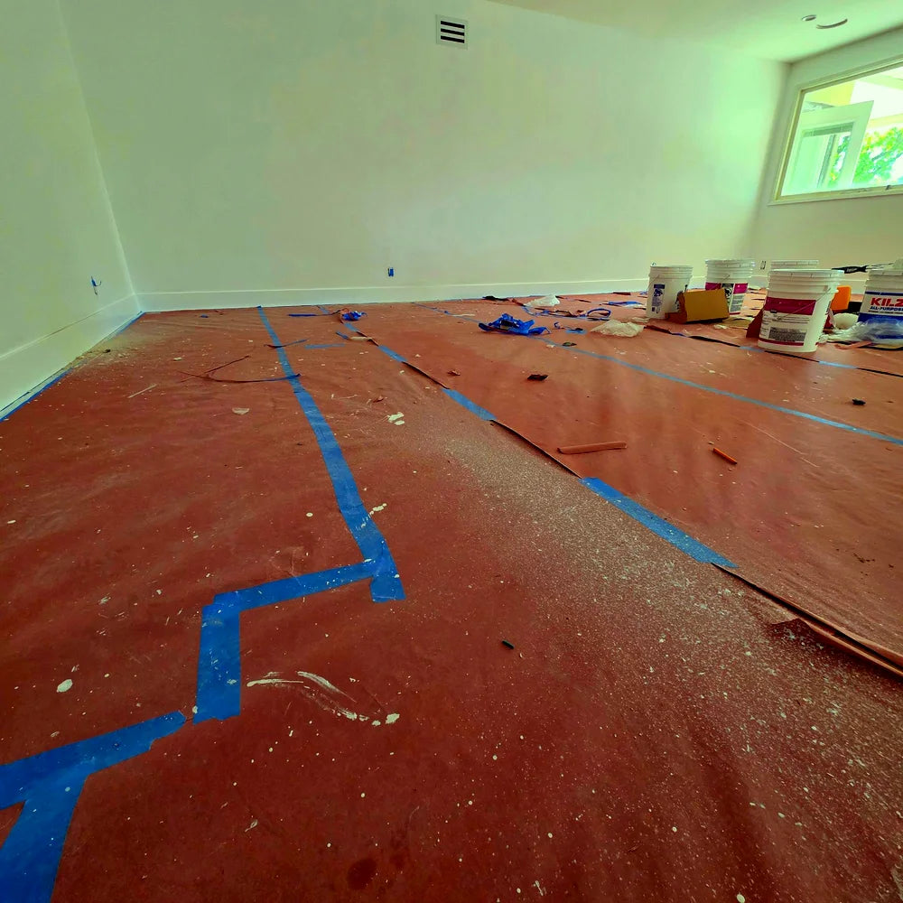 Floor protected with paper and blue painter's tape lines
